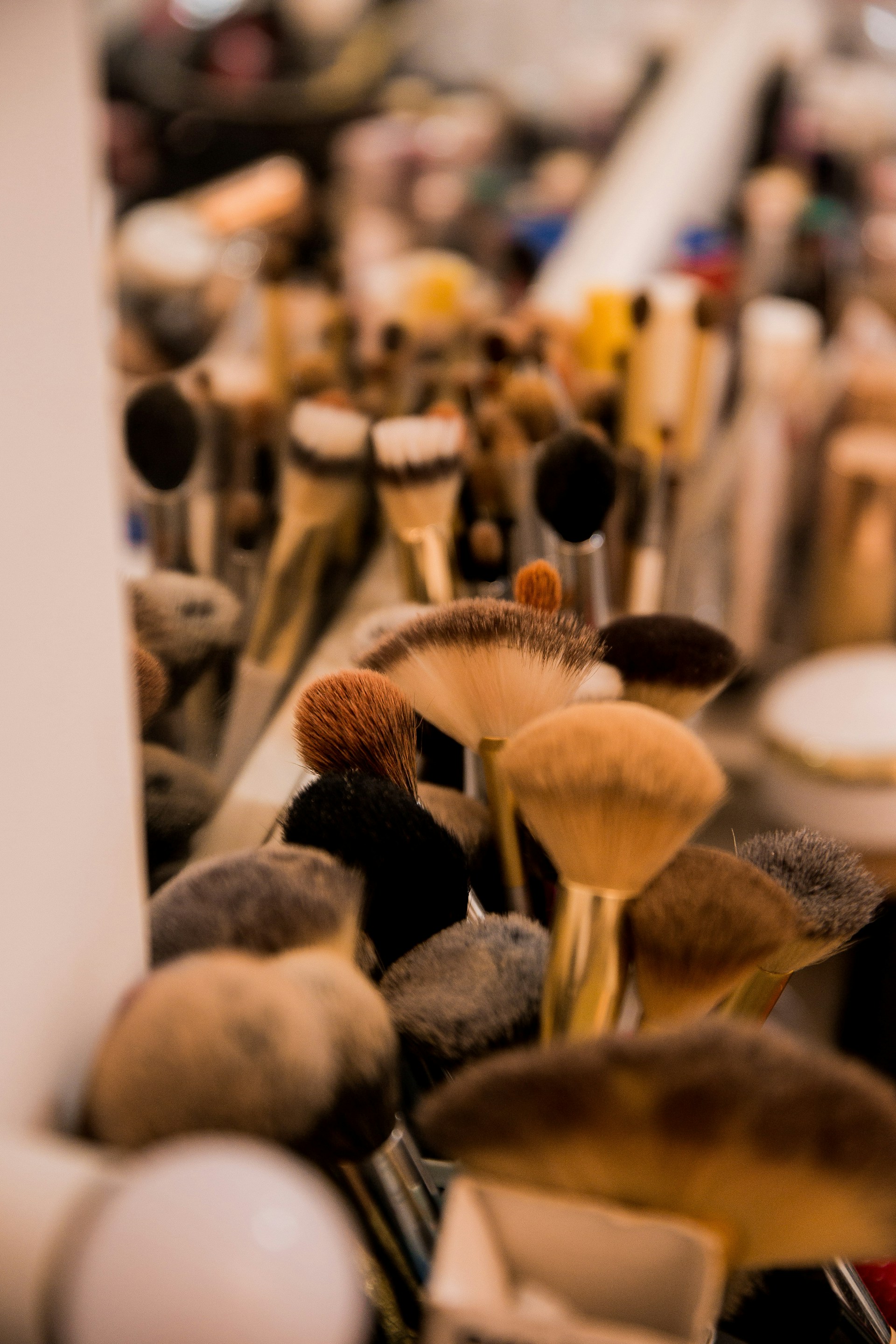 Modern salon interior and makeup brushes with warm copper accents